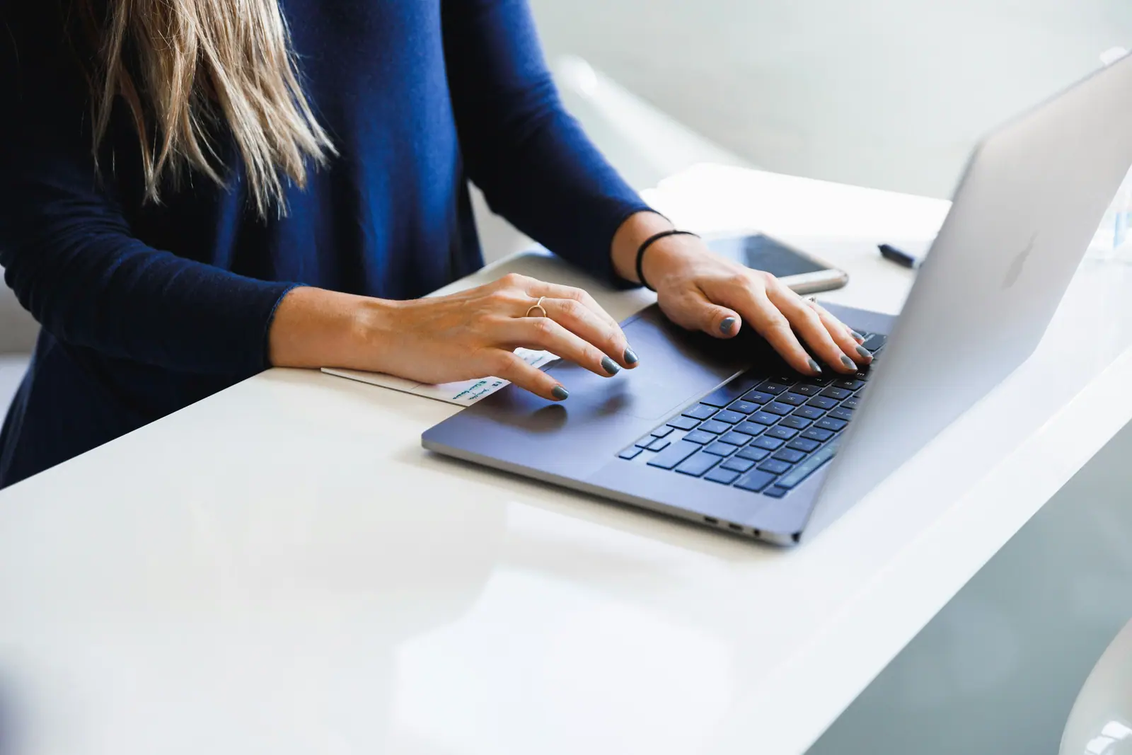 A fleet manager at a laptop in a bright office