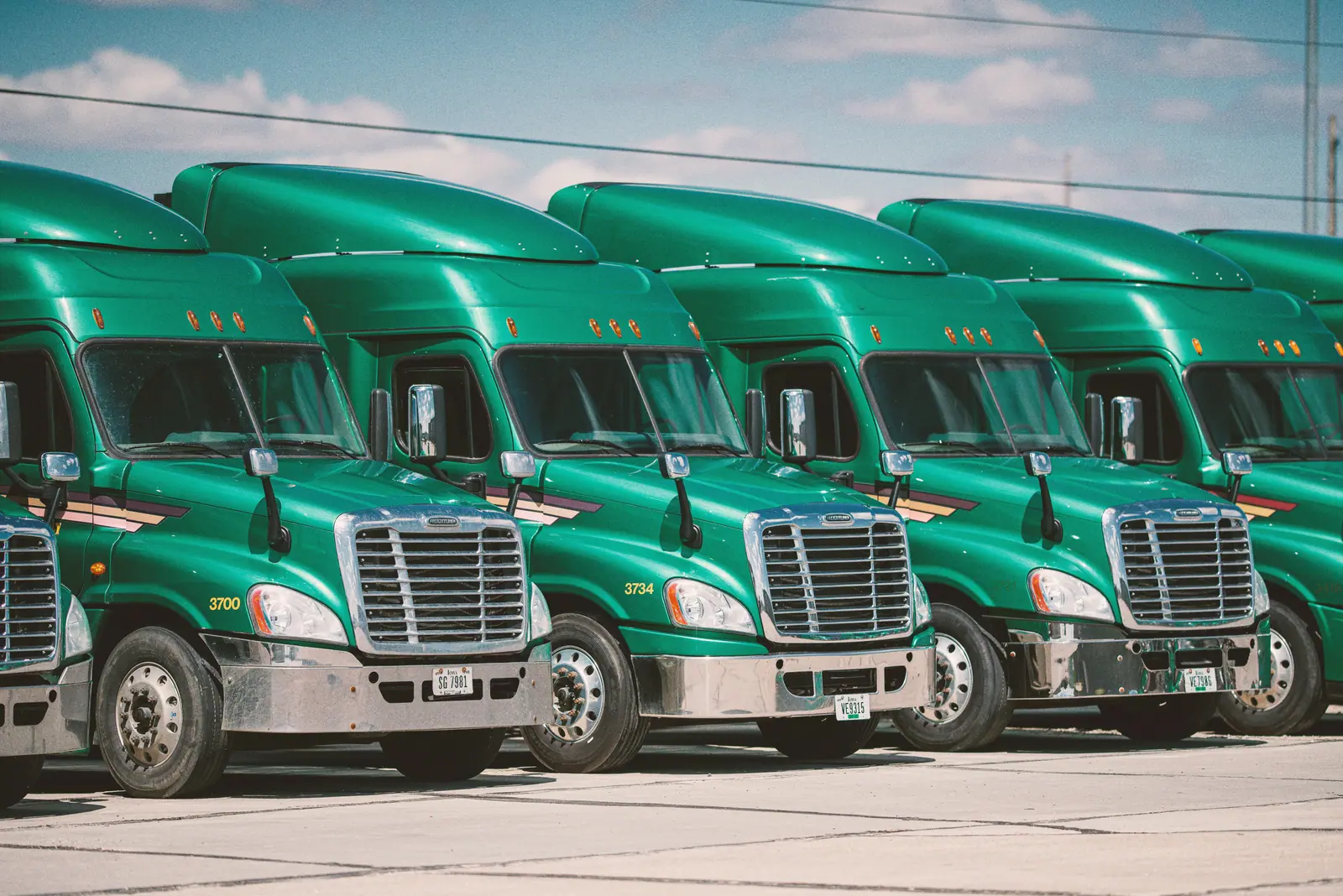 Trucks lined up in a yard, seen from above or at an angle