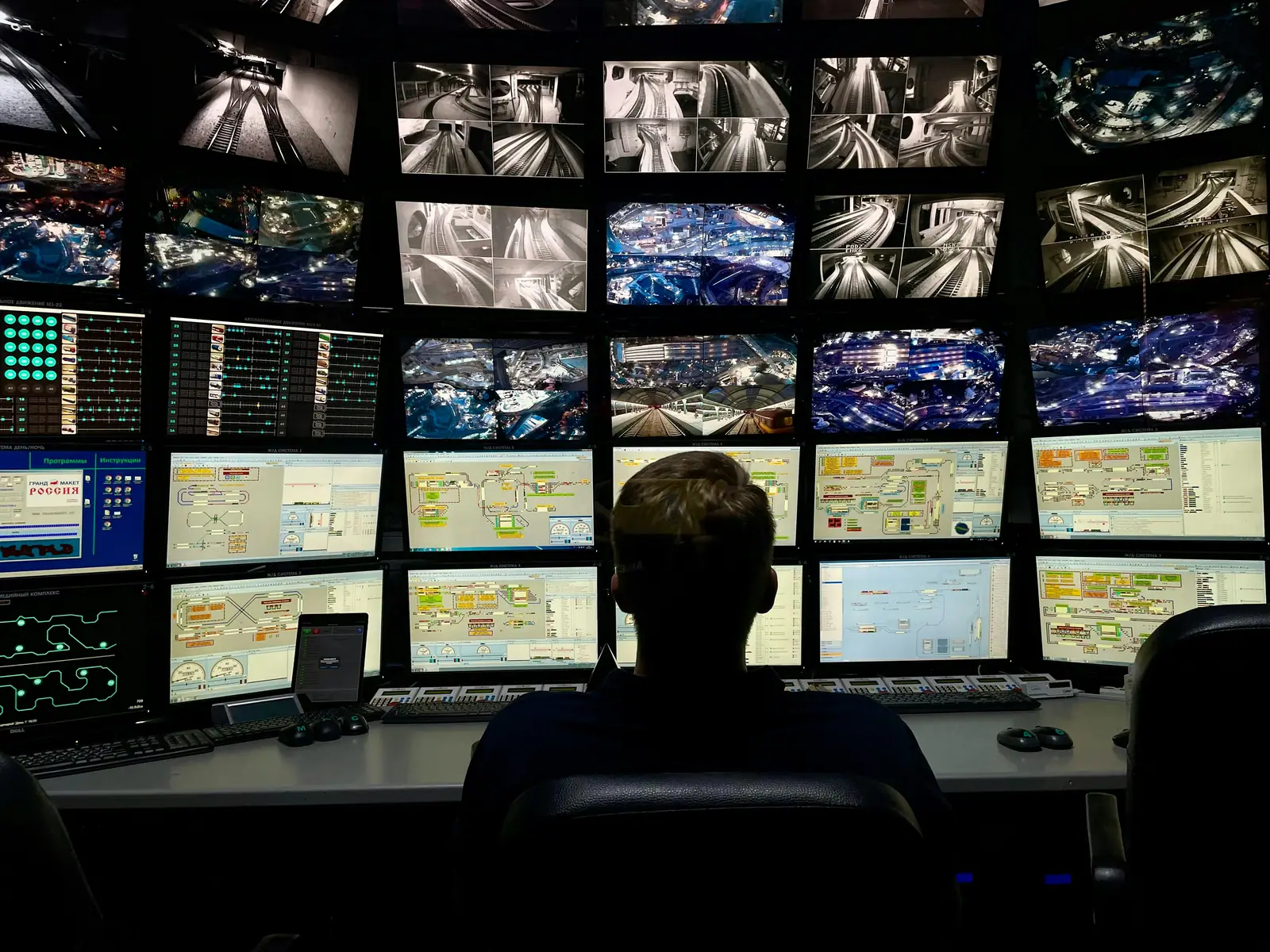 A dispatcher switching between several screens at a busy desk